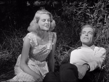 Movie still from “The Silence of the Sea” (1949), directed by Jean-Pierre Melville – A man and a woman sitting on the ground; Medium shot, Low angle