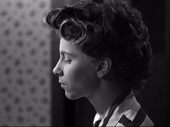 Movie still from “The Silence of the Sea” (1949), directed by Jean-Pierre Melville – A young woman is looking to the side; Close Up shot, Low angle