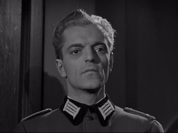 Movie still from “The Silence of the Sea” (1949), directed by Jean-Pierre Melville – A black and white photo of a man in a military uniform; Close Up shot, Low angle