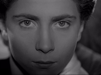 Movie still from “The Silence of the Sea” (1949), directed by Jean-Pierre Melville – A person's face in black - and - white; Close Up shot, High angle