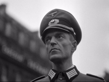 Movie still from “The Silence of the Sea” (1949), directed by Jean-Pierre Melville – An old photo of a man in a military uniform; Close Up shot, Low angle