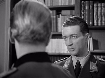 Movie still from “The Silence of the Sea” (1949), directed by Jean-Pierre Melville – A black and white photo of a man in a military uniform; Close Up shot, Over the shoulder angle