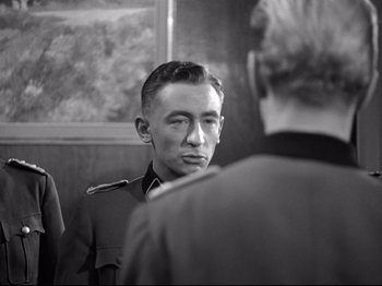 Movie still from “The Silence of the Sea” (1949), directed by Jean-Pierre Melville – A man in a military uniform looking at another man in a military uniform; Close Up shot, Over the shoulder angle