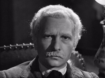 Movie still from “The Silence of the Sea” (1949), directed by Jean-Pierre Melville – An older man with a mustache and a mustache comb; Close Up shot, High angle