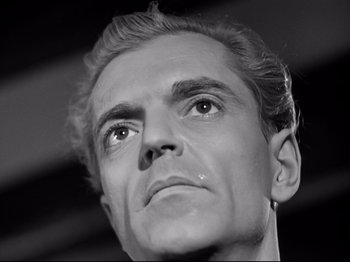Movie still from “The Silence of the Sea” (1949), directed by Jean-Pierre Melville – Black and white photograph of a man looking up; Close Up shot, Low angle