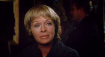 Movie still from “The Silent Partner” (1978), directed by Daryl Duke – A person with short blonde hair; Close Up shot, Over the shoulder angle