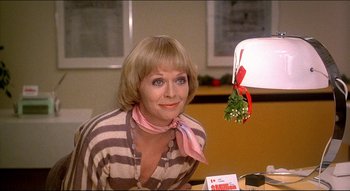 Movie still from “The Silent Partner” (1978), directed by Daryl Duke – A woman sitting at a table with a lamp in front of her; Close Up shot, Low angle