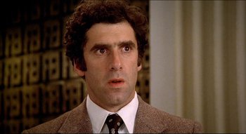 Movie still from “The Silent Partner” (1978), directed by Daryl Duke – A man in a suit and tie looking surprised; Close Up shot, Low angle