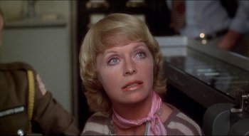 Movie still from “The Silent Partner” (1978), directed by Daryl Duke – A person with short blonde hair; Close Up shot, Over the shoulder angle