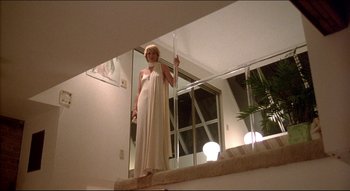 Movie still from “The Silent Partner” (1978), directed by Daryl Duke – A woman standing on the edge of a staircase; Wide shot, Low angle