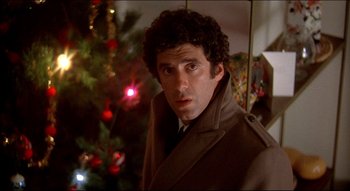 Movie still from “The Silent Partner” (1978), directed by Daryl Duke – A man standing in front of a christmas tree; Close Up shot, Low angle