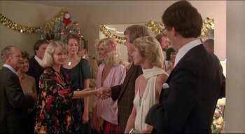 Movie still from “The Silent Partner” (1978), directed by Daryl Duke – A group of people standing in a room; Medium shot, Over the shoulder angle