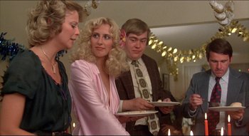 Movie still from “The Silent Partner” (1978), directed by Daryl Duke – A group of people standing in a room holding trays; Medium shot, Over the shoulder angle