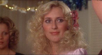 Movie still from “The Silent Partner” (1978), directed by Daryl Duke – A person with long hair; Close Up shot, Over the shoulder angle