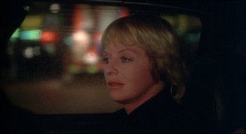 Movie still from “The Silent Partner” (1978), directed by Daryl Duke – A woman sitting in the back seat of a car; Close Up shot, Over the shoulder angle