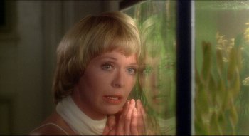Movie still from “The Silent Partner” (1978), directed by Daryl Duke – A woman with her hands clasped in front of a mirror; Close Up shot, Over the shoulder angle