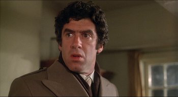 Movie still from “The Silent Partner” (1978), directed by Daryl Duke – A person wearing a suit and tie; Close Up shot, Low angle