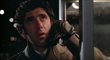 Movie still from “The Silent Partner” (1978), directed by Daryl Duke – A person talking on a cell phone; Close Up shot, Low angle