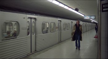Movie still from “The Silent Partner” (1978), directed by Daryl Duke – A woman is walking in a train station; Wide shot, High angle