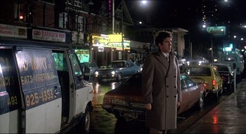 Movie still from “The Silent Partner” (1978), directed by Daryl Duke – A man standing in the middle of a street; Wide shot, Low angle