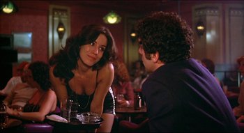 Movie still from “The Silent Partner” (1978), directed by Daryl Duke – A man and a woman are sitting at a table; Medium shot, Over the shoulder angle