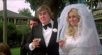 Movie still from “The Silent Partner” (1978), directed by Daryl Duke – A man and a woman in a tuxedo and a woman in a wedding dress; Close Up shot, Low angle
