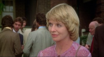 Movie still from “The Silent Partner” (1978), directed by Daryl Duke – A person wearing a pink shirt; Close Up shot, Over the shoulder angle
