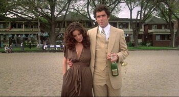 Movie still from “The Silent Partner” (1978), directed by Daryl Duke – A man and a woman standing next to each other; Medium shot, Low angle