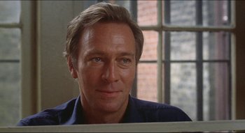 Movie still from “The Silent Partner” (1978), directed by Daryl Duke – A person wearing a blue shirt; Close Up shot, Low angle