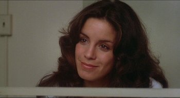 Movie still from “The Silent Partner” (1978), directed by Daryl Duke – A person with long brown hair; Close Up shot, Low angle