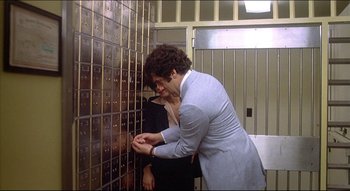 Movie still from “The Silent Partner” (1978), directed by Daryl Duke – A man and a woman looking into a safe; Medium shot, Low angle
