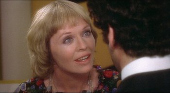 Movie still from “The Silent Partner” (1978), directed by Daryl Duke – An older woman talking to a younger man in a room; Close Up shot, Over the shoulder angle