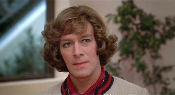 Movie still from “The Silent Partner” (1978), directed by Daryl Duke – A person wearing a sweater; Close Up shot, Over the shoulder angle