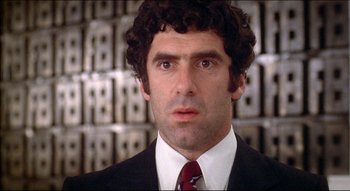 Movie still from “The Silent Partner” (1978), directed by Daryl Duke – A man in a suit and a tie; Close Up shot, Low angle