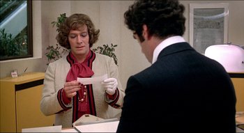 Movie still from “The Silent Partner” (1978), directed by Daryl Duke – A man and a woman are looking at a piece of paper; Close Up shot, Over the shoulder angle