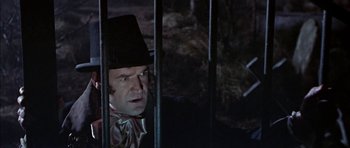 Movie still from “The Skull” (1965), directed by Freddie Francis – A man wearing a top hat and a tie; Close Up shot, Low angle
