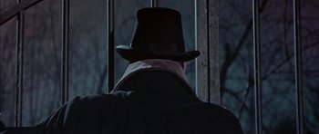 Movie still from “The Skull” (1965), directed by Freddie Francis – A man wearing a top hat looking out of a window; Close Up shot, Low angle