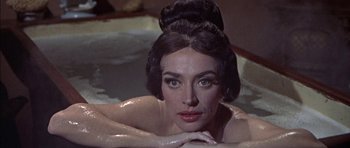 Movie still from “The Skull” (1965), directed by Freddie Francis – A woman in a bathtub with her hands on her chest; Close Up shot, High angle