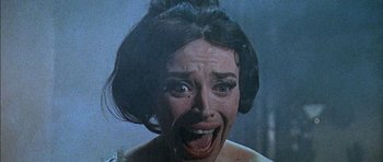 Movie still from “The Skull” (1965), directed by Freddie Francis – A woman's face as she stares at the camera; Close Up shot, Low angle