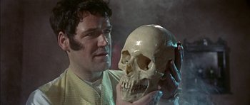 Movie still from “The Skull” (1965), directed by Freddie Francis – A man holding a skull in his hands; Close Up shot, Over the shoulder angle