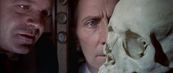 Movie still from “The Skull” (1965), directed by Freddie Francis – A person holding a skull; Close Up shot, Overhead angle