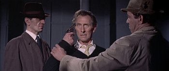 Movie still from “The Skull” (1965), directed by Freddie Francis – A man holding a cell phone up to his ear; Medium shot, High angle