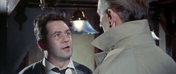 Movie still from “The Skull” (1965), directed by Freddie Francis – A man talking to another man wearing a suit; Close Up shot, Over the shoulder angle