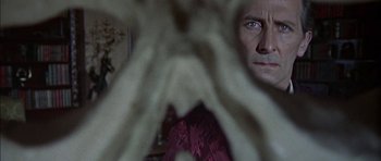 Movie still from “The Skull” (1965), directed by Freddie Francis – A man's face in a room; Close Up shot, Over the shoulder angle