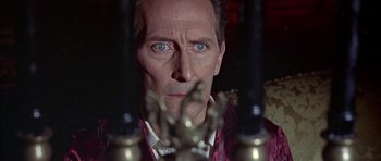 Movie still from “The Skull” (1965), directed by Freddie Francis – A man's face in front of candles; Close Up shot, Over the shoulder angle