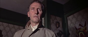 Movie still from “The Skull” (1965), directed by Freddie Francis – A person wearing a coat; Close Up shot, Low angle