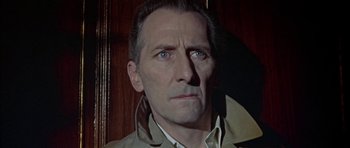 Movie still from “The Skull” (1965), directed by Freddie Francis – A person wearing a jacket; Close Up shot, High angle