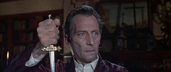 Movie still from “The Skull” (1965), directed by Freddie Francis – A person holding a sword; Close Up shot, Over the shoulder angle