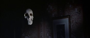 Movie still from “The Skull” (1965), directed by Freddie Francis – A skull hanging from the ceiling of a dark room; Close Up shot, Low angle