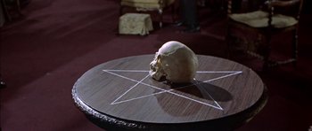 Movie still from “The Skull” (1965), directed by Freddie Francis – A skull sitting on top of a wooden table; Extreme Close Up shot, High angle